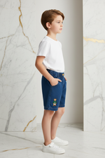 Boy wearing denim shorts - left side view