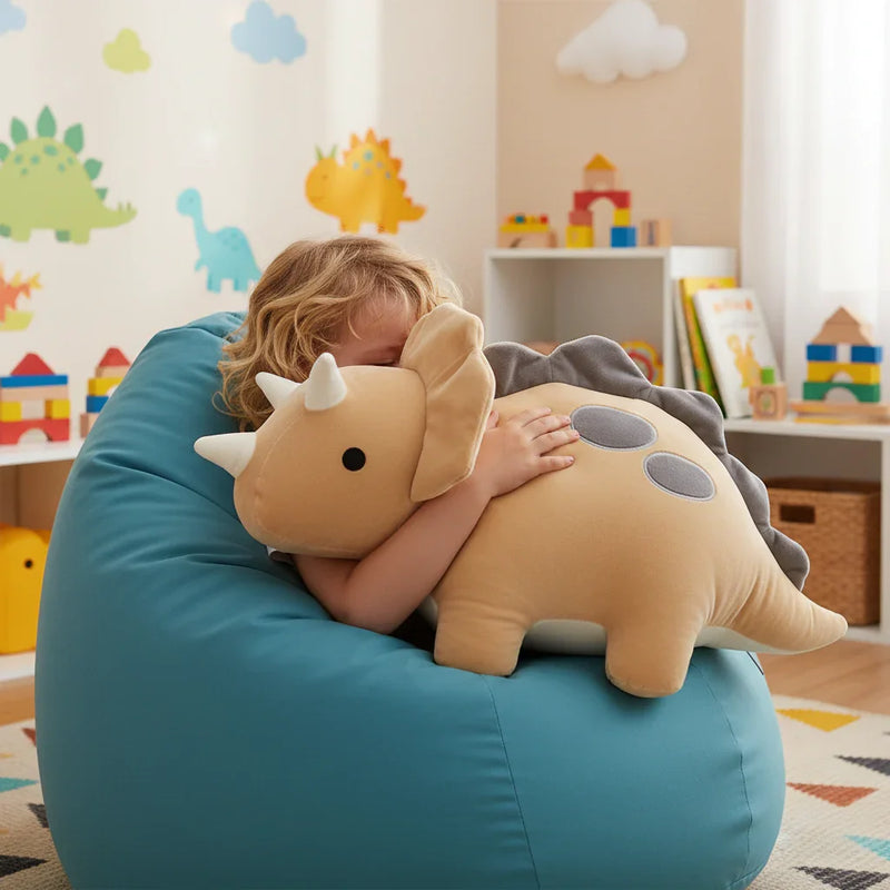 Child cuddling beige dinosaur plush