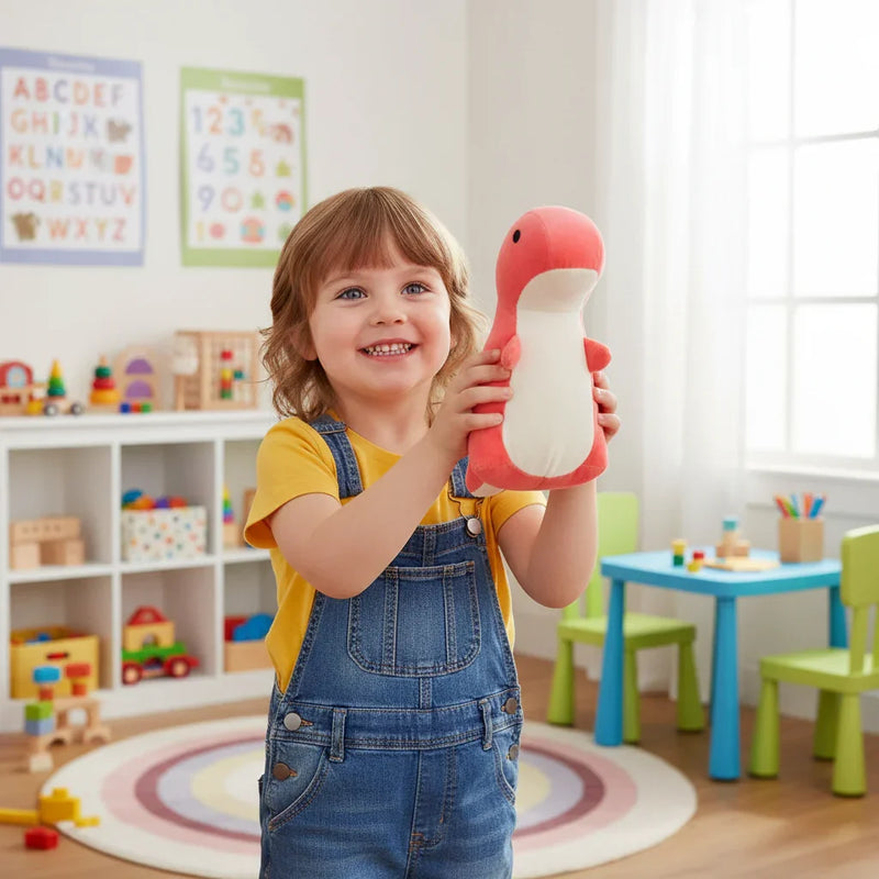 Child holding coral pink dinosaur plush