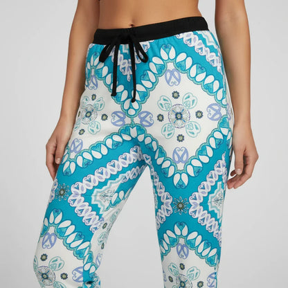 Close-up of teal and white patterned women's jogger pants with black drawstring, Ivorynn fashion