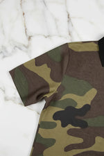 Close-up of camo fabric short sleeve shirt on white marble surface, Ivorynn fashion