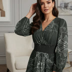 Woman wearing a long sleeve patterned dress from Ivorynn, posed in a modern living room