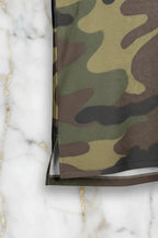 Close-up of camo fabric hem and side seam on marble background, Ivorynn apparel detail