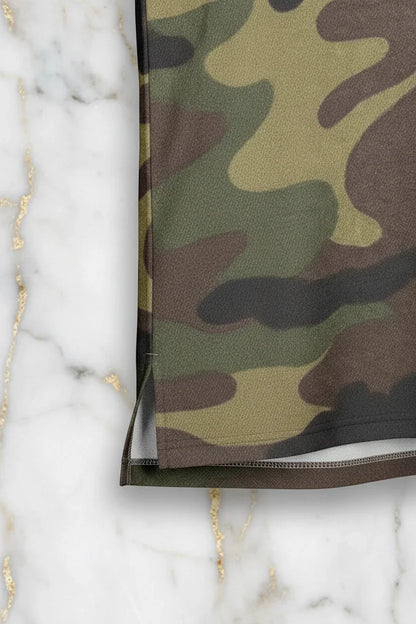 Close-up of camo fabric hem and side seam on marble background, Ivorynn apparel detail