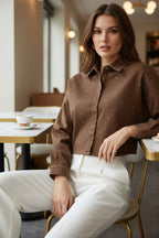 Close-up of brown denim shirt rhinestones with white pants