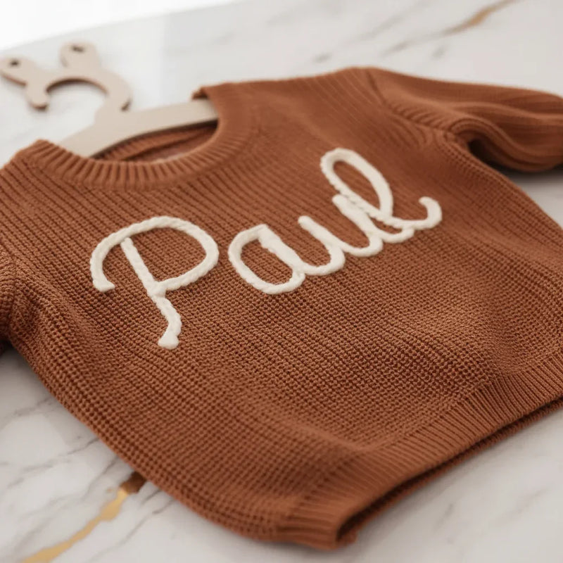 Close-up of "Paul" embroidered text