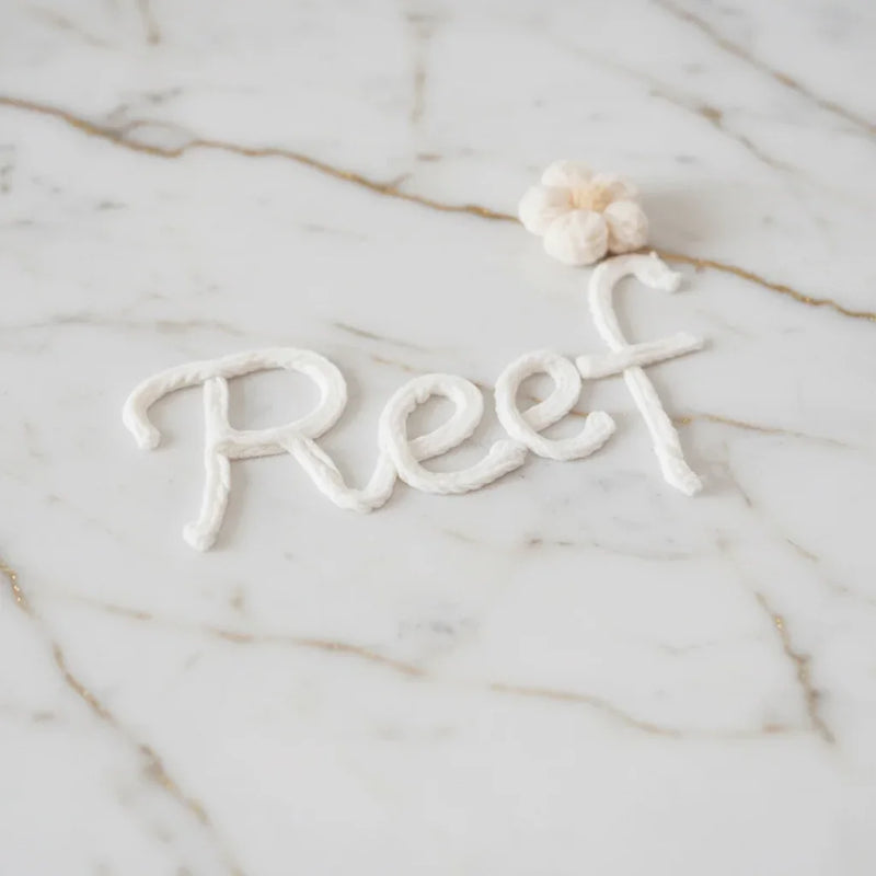 Close-up of "Reef" embroidered text