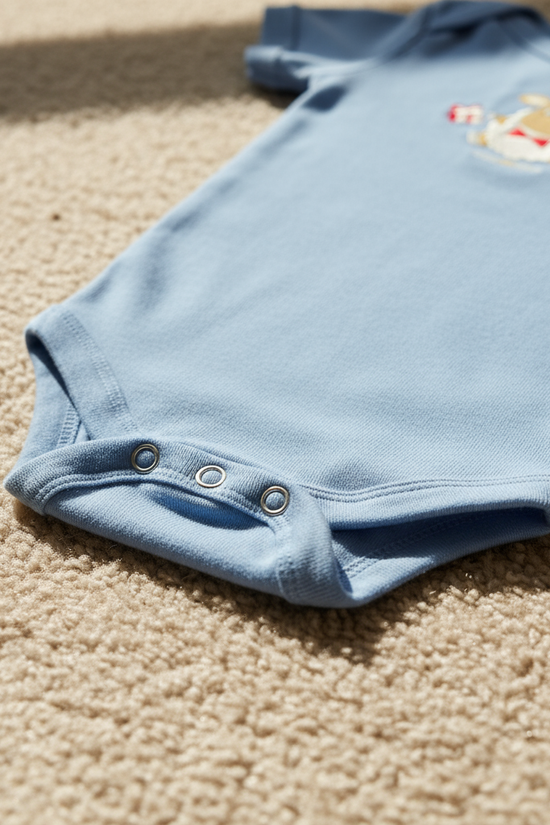 Close-up of snap closures and fabric detail on beige carpet