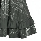 Close-up of a dark ruffle hem skirt with white sketch pattern, stylish women's apparel at Ivorynn