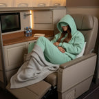 Curled up comfortably in reclined seat