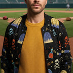 Man wearing a colorful patterned jacket and yellow sweater at a baseball field, Ivorynn fashion
