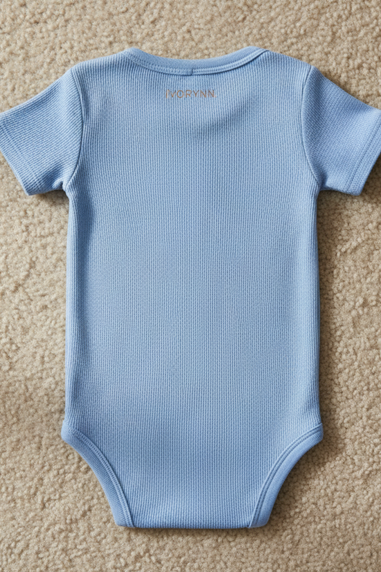 Detailed close-up of back fabric and IVORYNN text on beige carpet