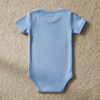 Detailed close-up of back fabric and IVORYNN text on beige carpet