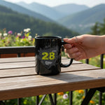 Hand holding black dubstep mug on wooden table outdoors with mountain view, Ivorynn style