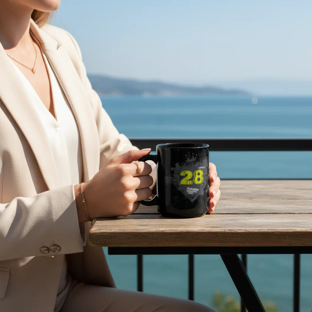 Woman in beige suit holding black dubstep mug at outdoor table with ocean view
