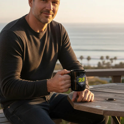 Man on patio holding black dubstep mug, ocean view in background, Ivorynn lifestyle