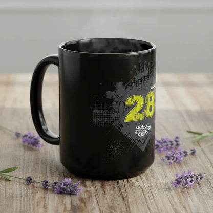 Black dubstep party mug with yellow graphics on wooden table, surrounded by lavender flowers.
