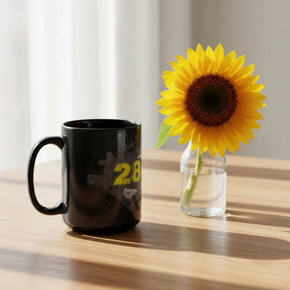 Black dubstep mug beside vibrant sunflower in glass vase on wooden table, Ivorynn home decor