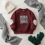 Fleece sweater on cream marble with cozy accessories