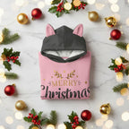 Folded hoodie with ornaments, holly, and twinkling lights