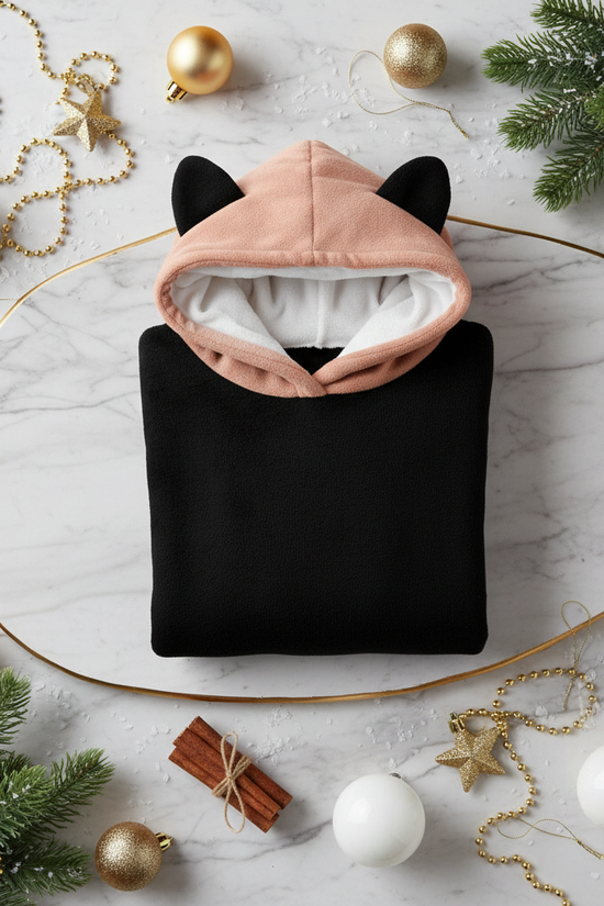 Folded hoodie with white and gold baubles and evergreen