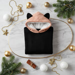 Folded hoodie with white and gold baubles and evergreen