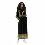 Woman in black and gold hooded maxi dress with modern ethnic pattern, Ivorynn fashion