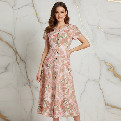 Woman modeling pink floral button-down dress in front of marble wall, Ivorynn fashion