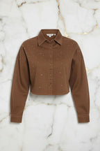 Front view of brown denim shirt on marble background