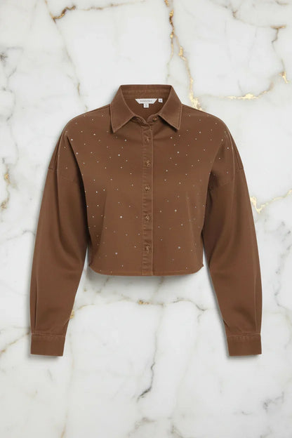 Front view of brown denim shirt on marble background