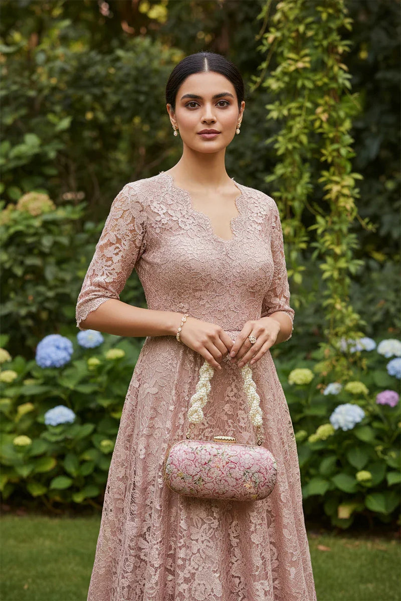 Front view of woman holding pink clutch