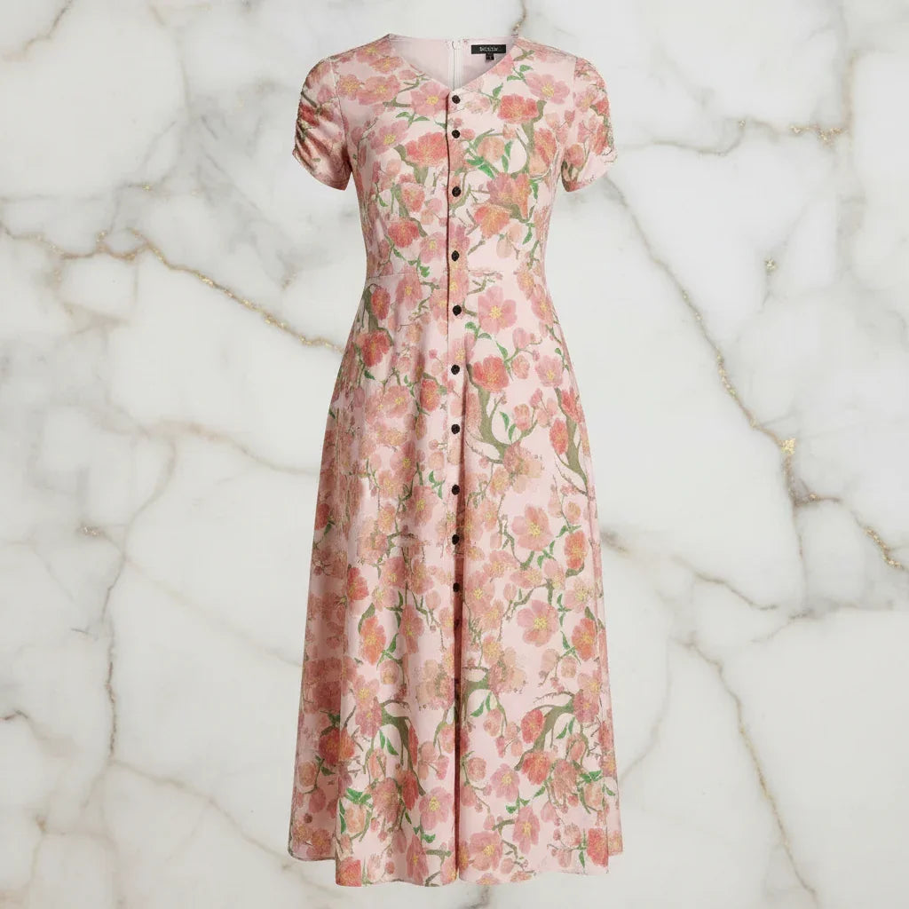 Pink floral button-down dress for women from Ivorynn on a marble background