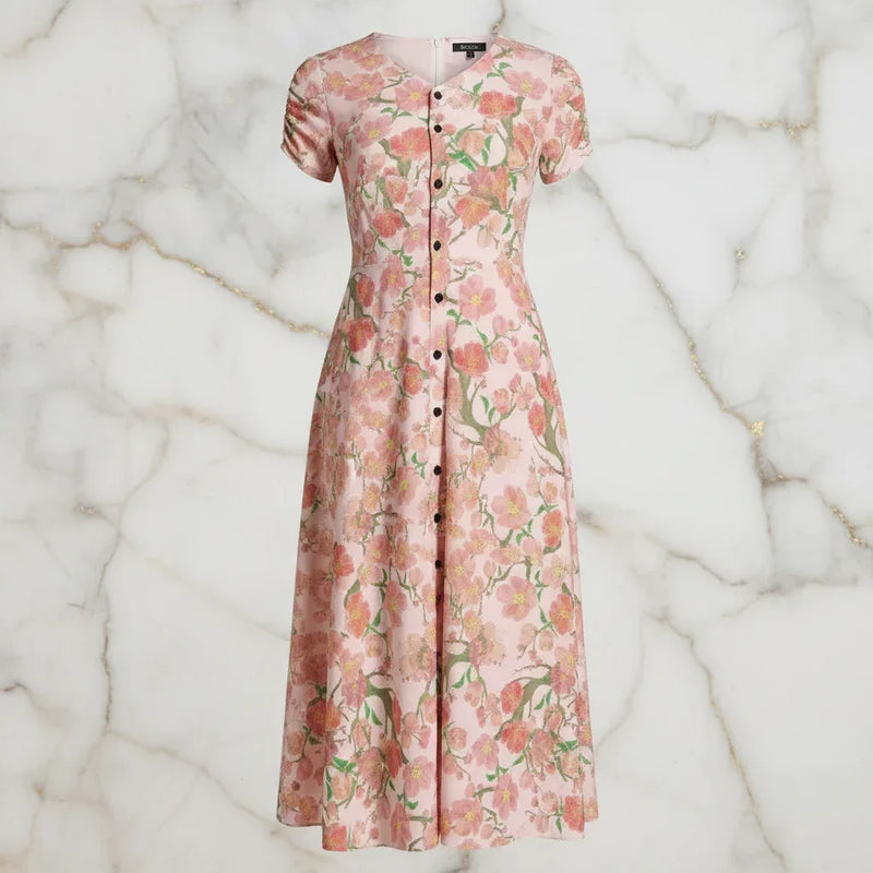 Pink floral button-down dress for women from Ivorynn on a marble background