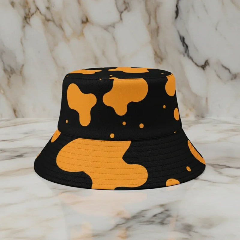 Black and orange abstract pattern bucket hat on marble surface, stylish modern accessory at Ivorynn.