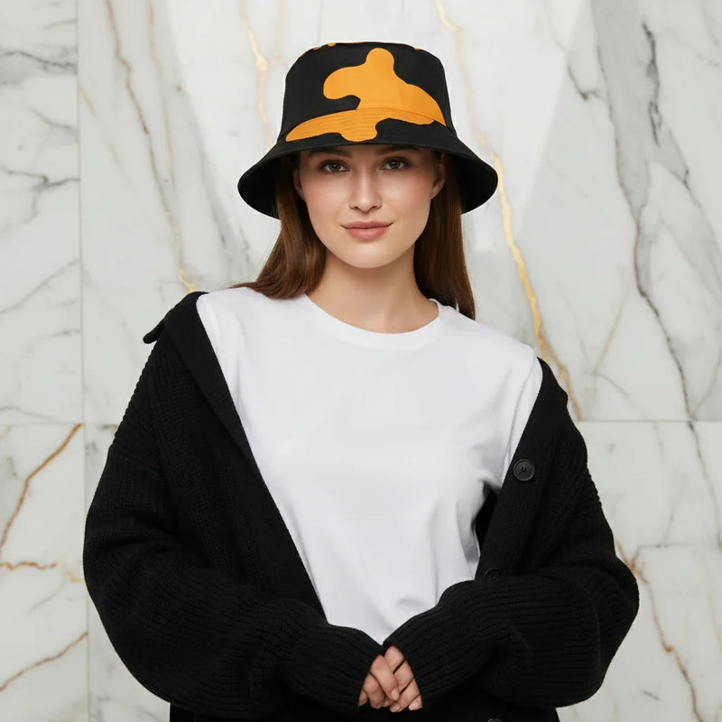 Woman in black cardigan, white shirt, and black bucket hat with yellow pattern, Ivorynn fashion