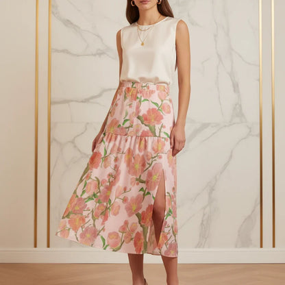 Woman in sleeveless white top and floral pink midi skirt with front slit, Ivorynn fashion