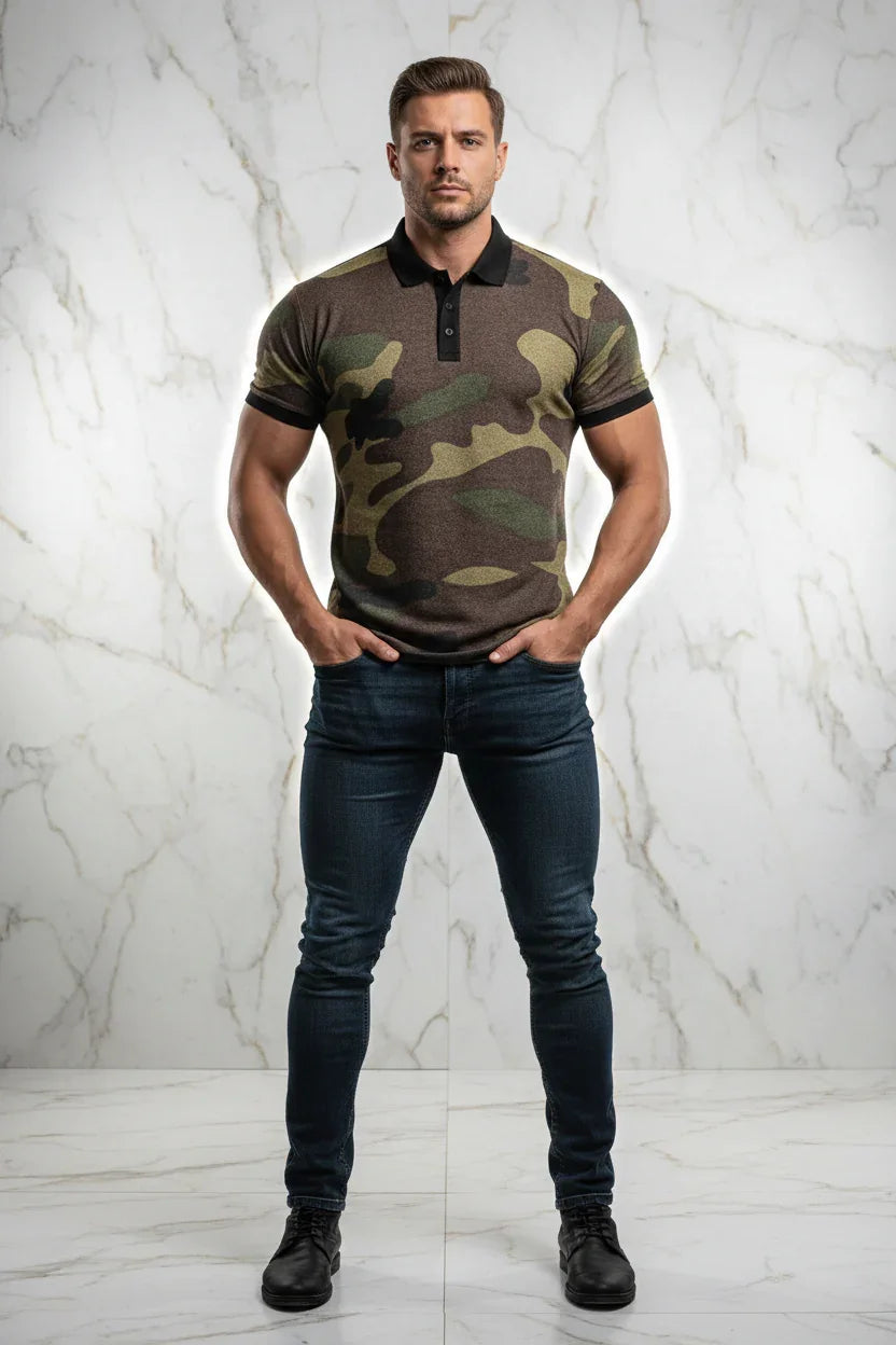 Man wearing a camouflage polo shirt, dark jeans, and black shoes, standing against a marble wall at Ivorynn.