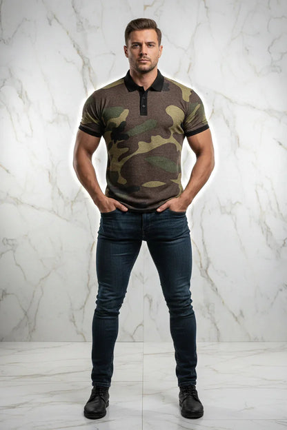 Man wearing a camouflage polo shirt, dark jeans, and black shoes, standing against a marble wall at Ivorynn.