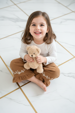Girl Sitting with Teddy Bear