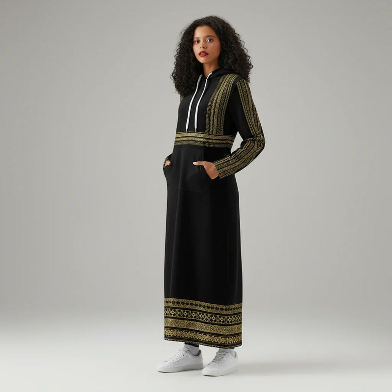 Woman in a black and gold embroidered hoodie dress, white sneakers, studio backdrop, Ivorynn fashion