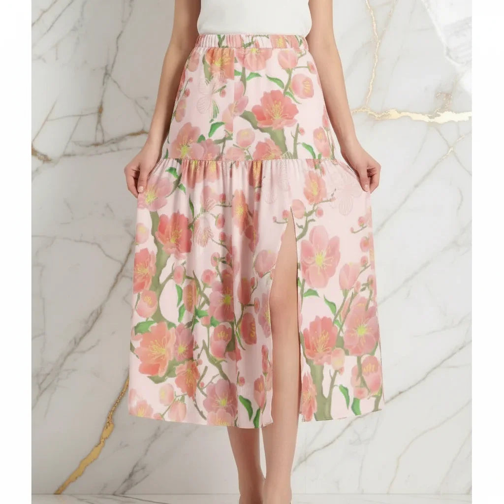Woman wearing pink floral skirt with slit, stylish apparel from Ivorynn, marble background