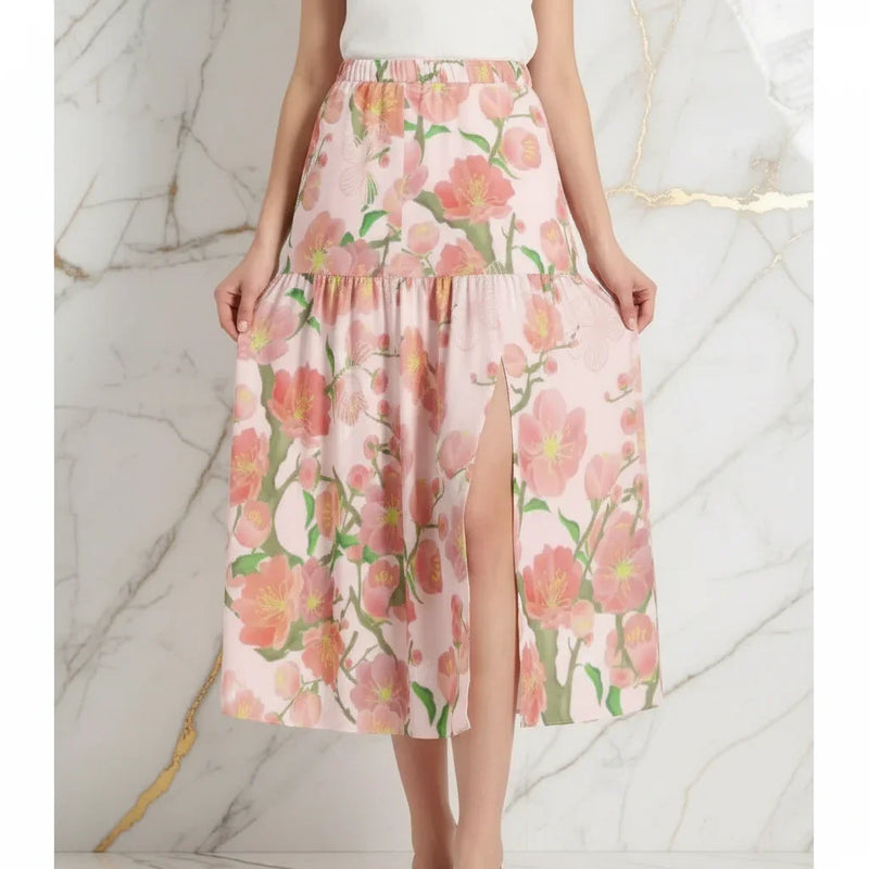 Woman wearing pink floral skirt with slit, stylish apparel from Ivorynn, marble background
