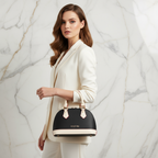 IVORYNN bag held by handle - side angle on gold marble