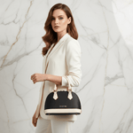 IVORYNN bag held by handle - side angle on gold marble