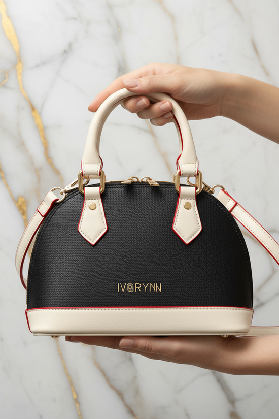 IVORYNN bag held - front view on gold marble