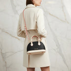 IVORYNN bag worn crossbody - back angle on gold marble