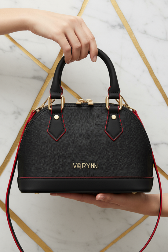 IVORYNN black bag held - front view on gold marble