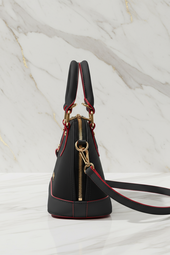 IVORYNN black bag - side angle view on gold marble