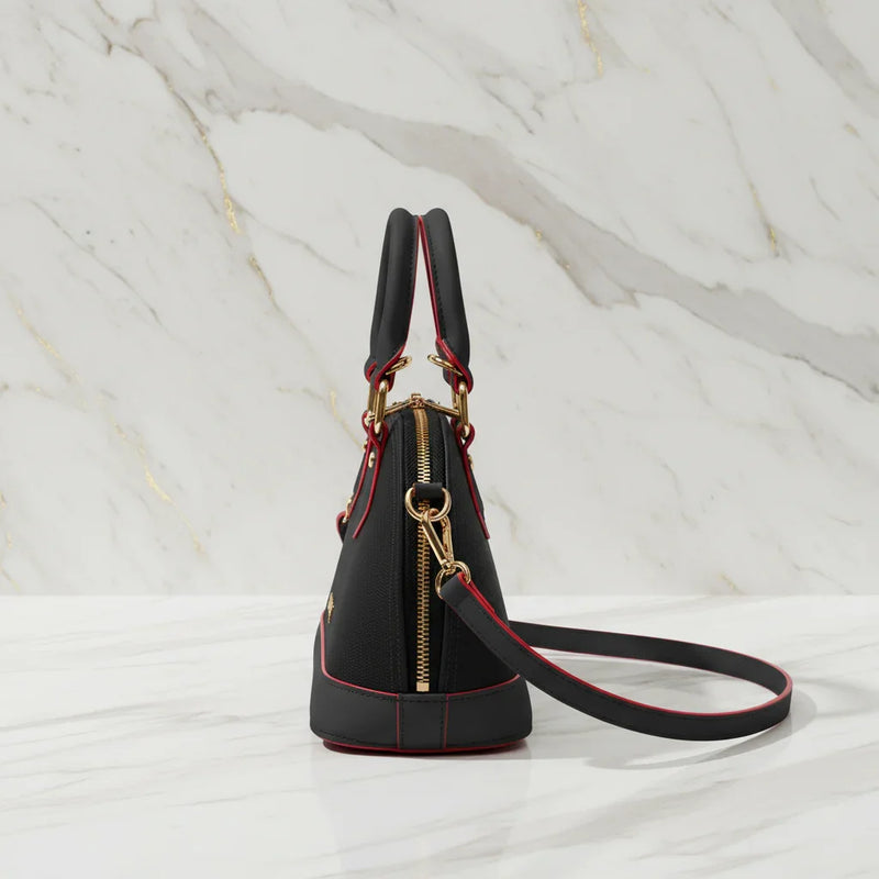 IVORYNN black bag - side angle view on gold marble