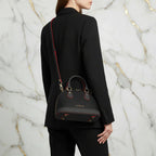IVORYNN black bag worn crossbody - back angle on gold marble